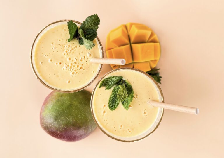 Indisches Getränk Mango Lassi mit frischer Mango, Mandelmilch, Sojajoghurt, Zitronensaft und Zimt. Gesund und einfach in 5 Minuten zubereitet.